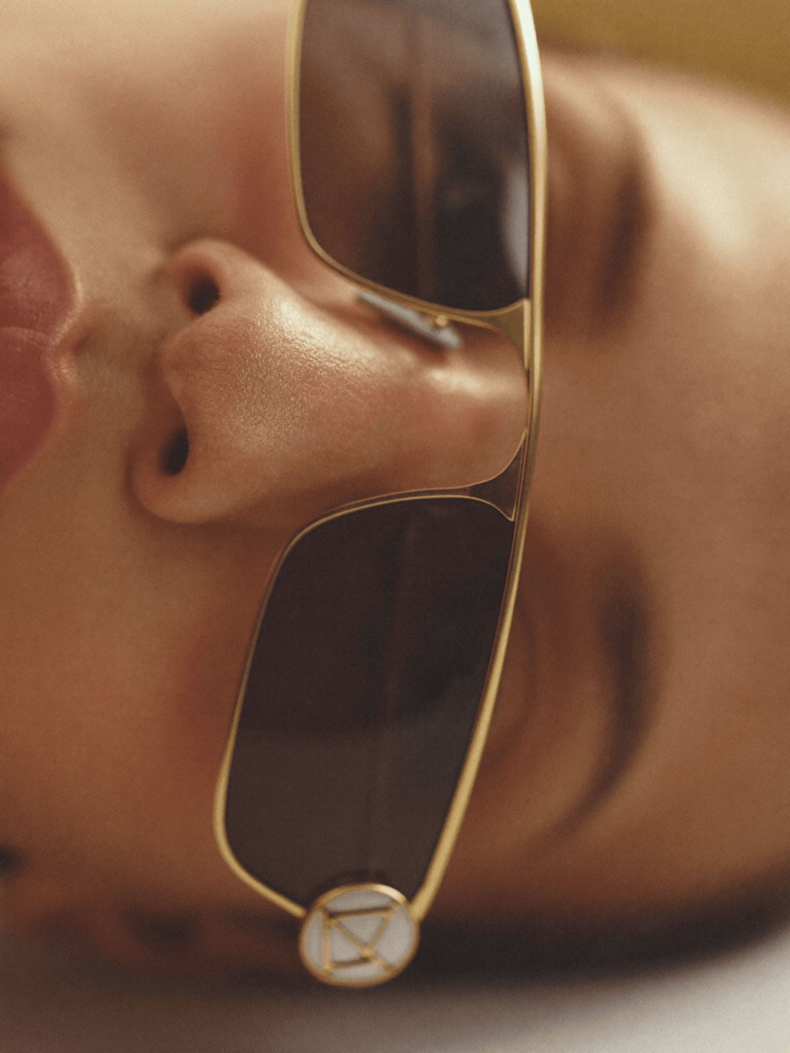 Close-up of luxury sunglasses on skin